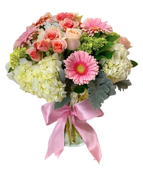 Roses, gerbera daisies and hydrangea tied with a pink bow